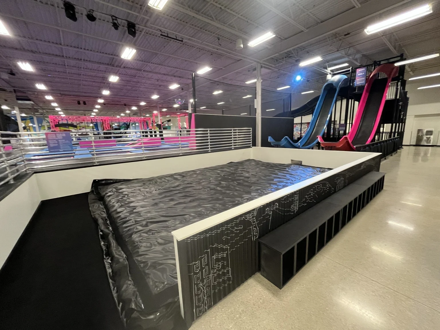 Finished activity area with overhead lighting and indoor attractions at Altitude Chicago.