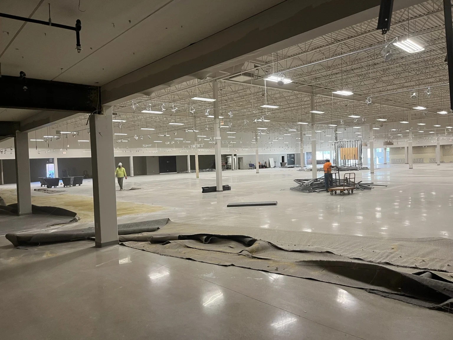 Large open interior at Altitude Chicago during construction, with overhead lighting and exposed building systems.