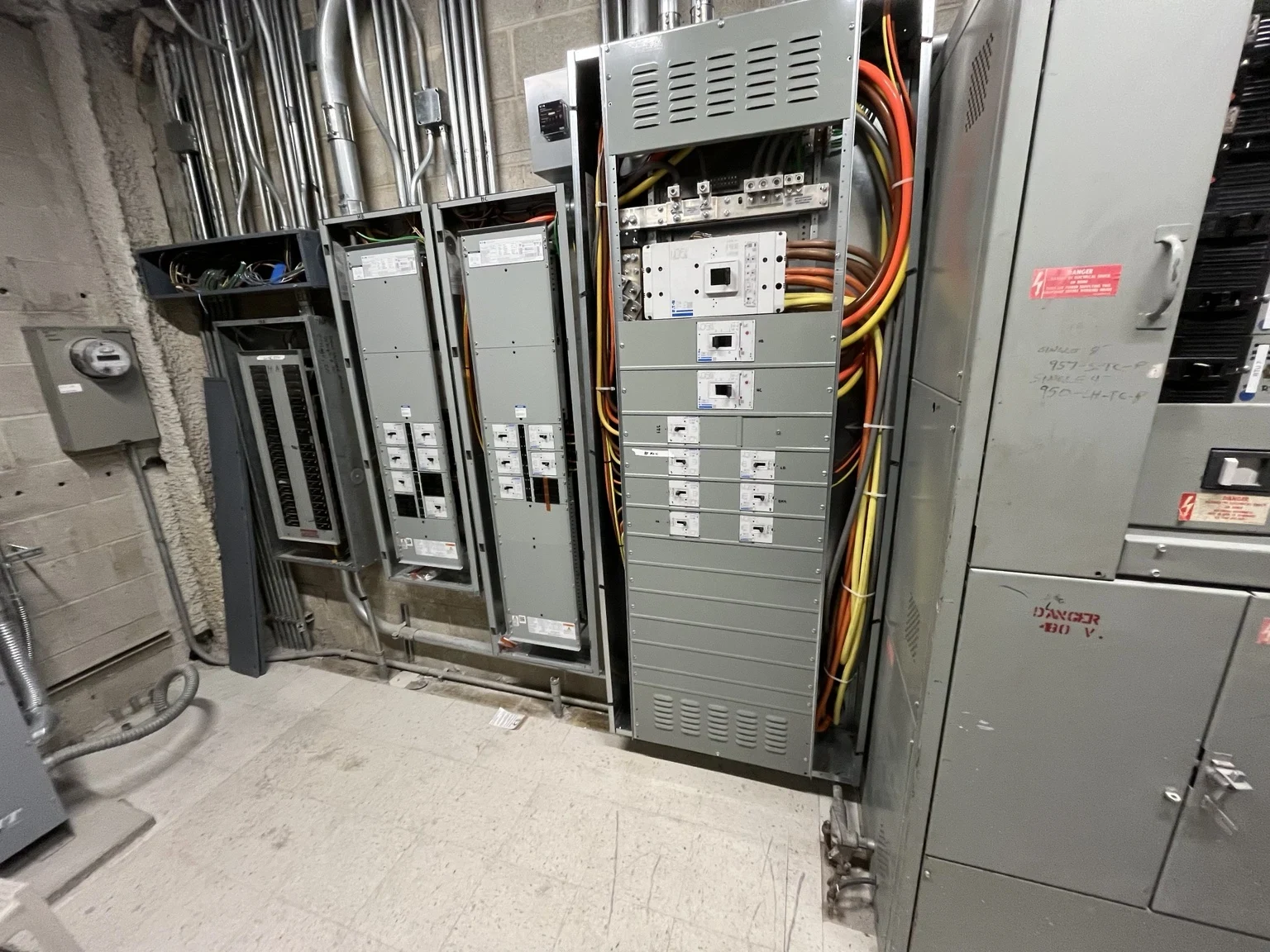 Electrical distribution equipment and overhead conduit inside the Altitude project electrical room.