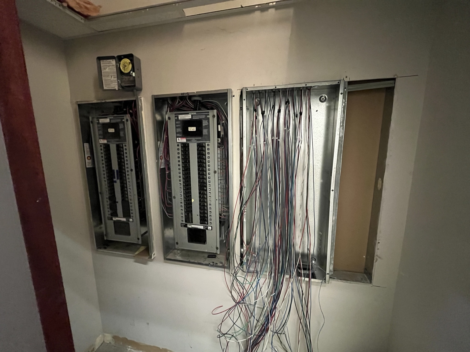 Electrical distribution panels and branch-circuit wiring during the office renovation.