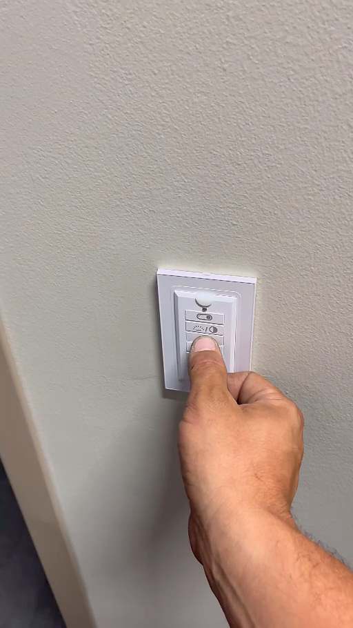 Wall-mounted lighting control in the renovated office.