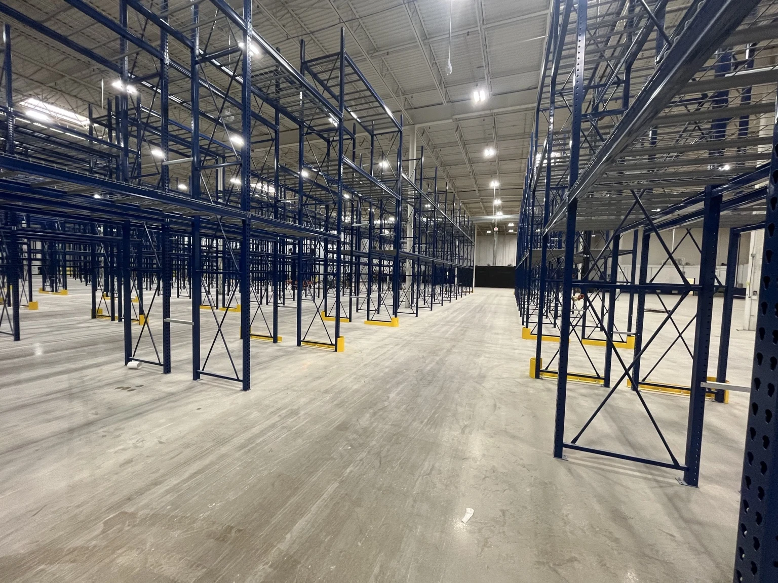 High-bay lighting serving the aisles defined by the warehouse storage-racking layout at Garrett Popcorn in Aurora.