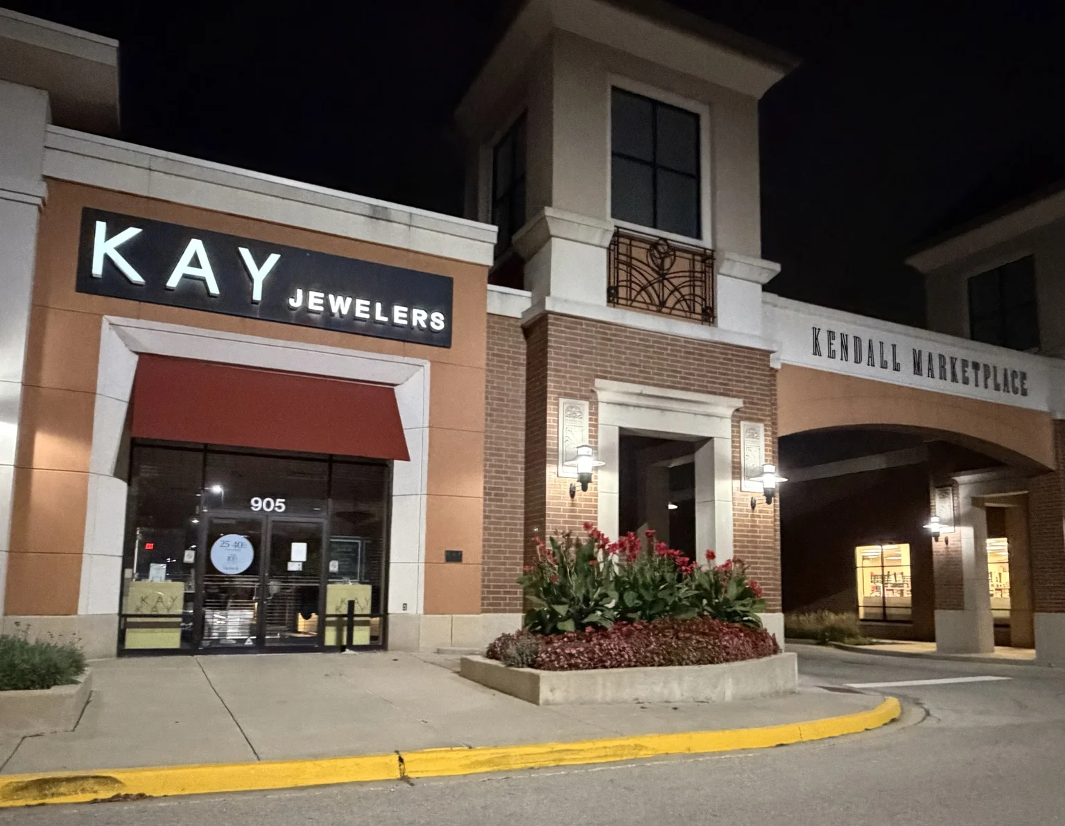 Architectural lighting at the Kendall Marketplace entrance beside Kay Jewelers.