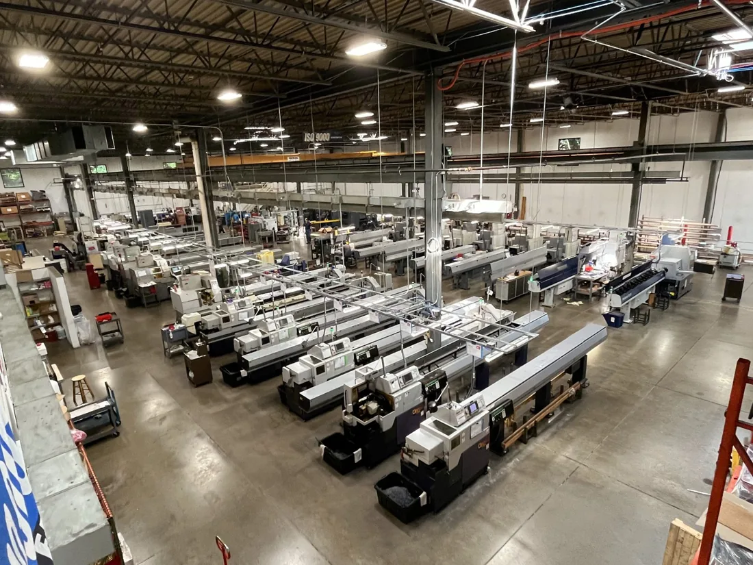 Machine rows and overhead lighting at the Bloomingdale CNC shop