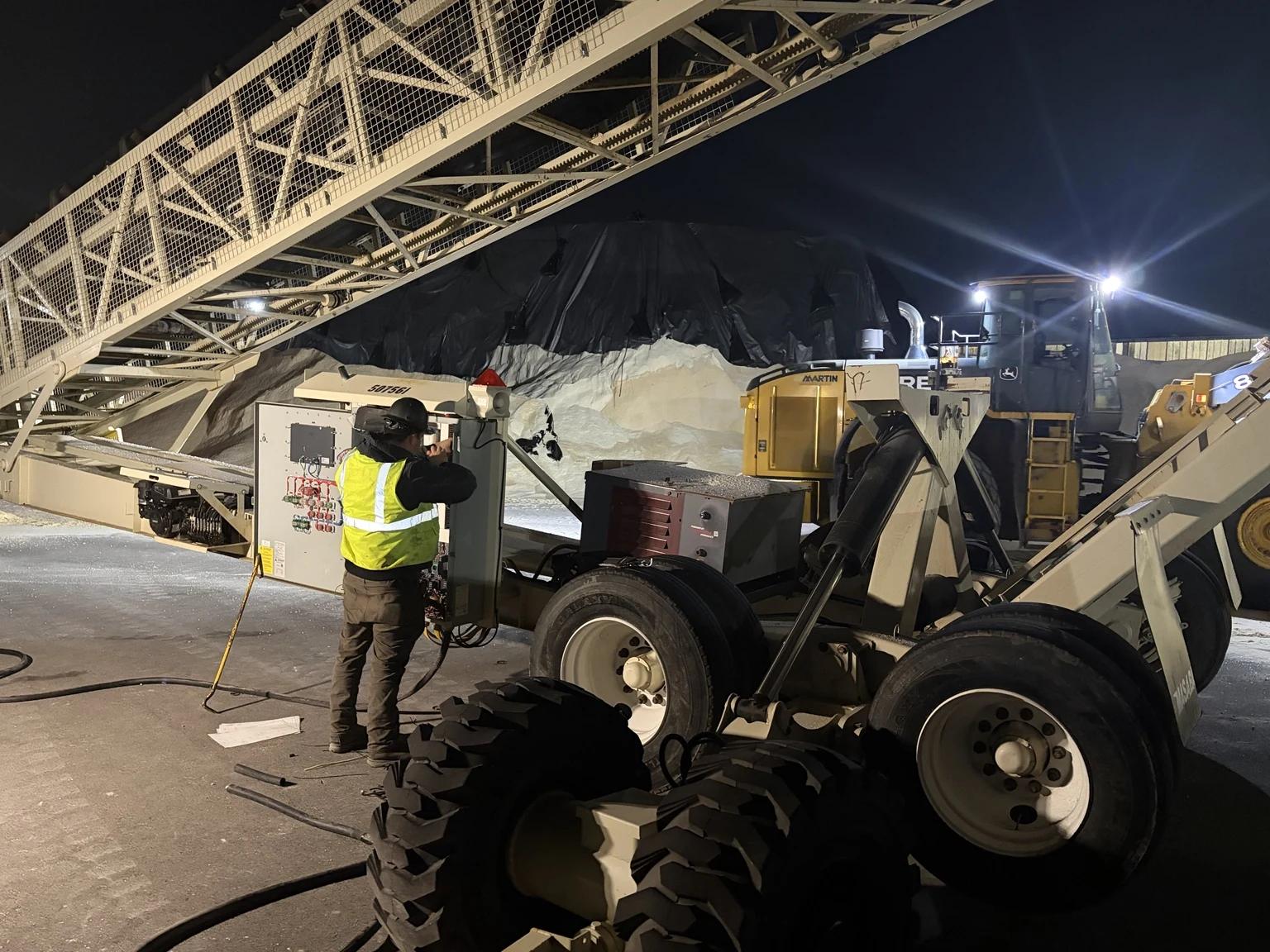 Conveyor and surrounding equipment during nighttime electrical service.
