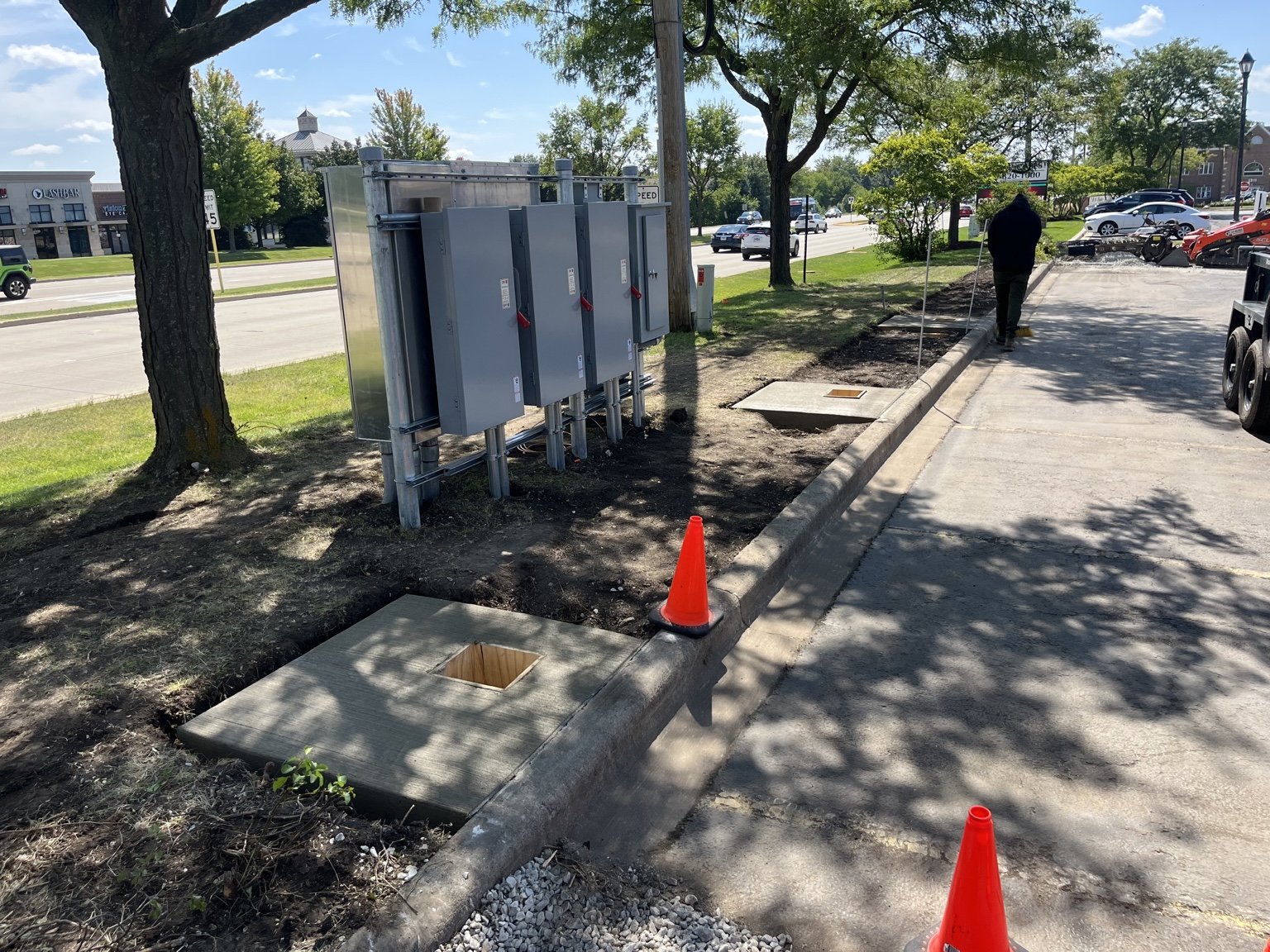Electrical equipment and a concrete equipment pad during site preparation in Naperville.