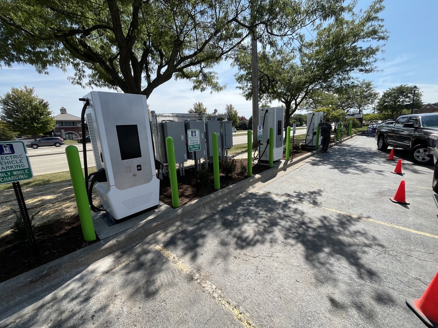 Row of EV charging stations with protective bollards at the Naperville project.
