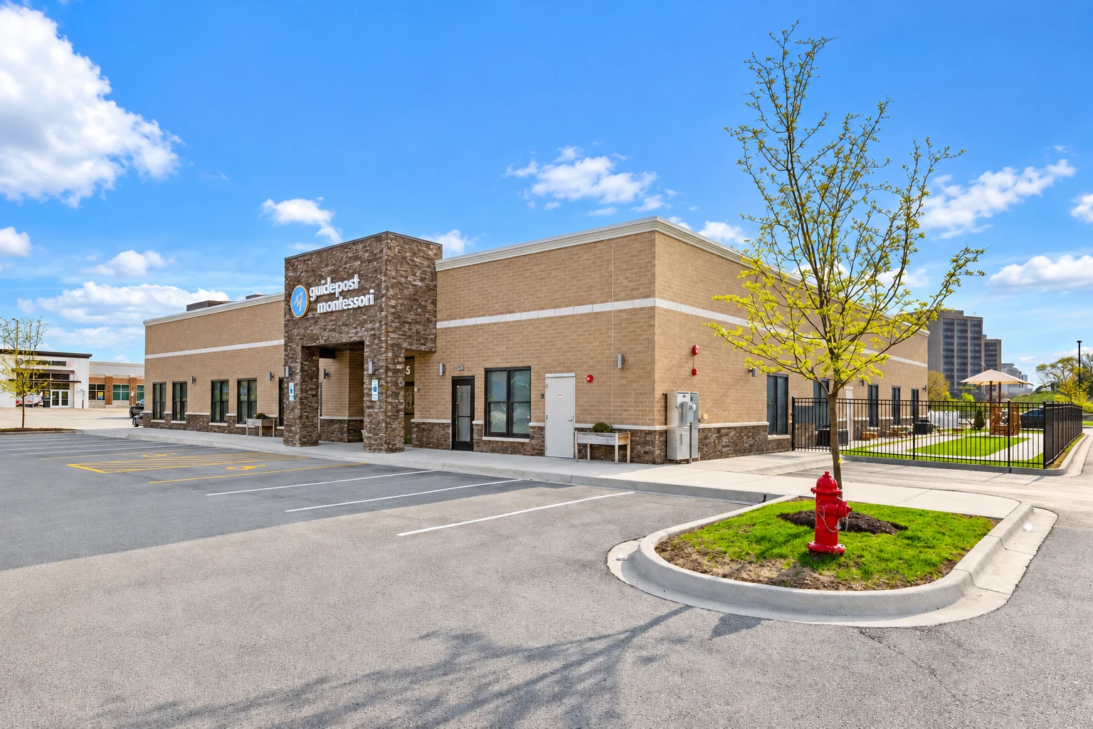 Completed brick commercial building and surrounding parking at The Overlook at Oakbrook.