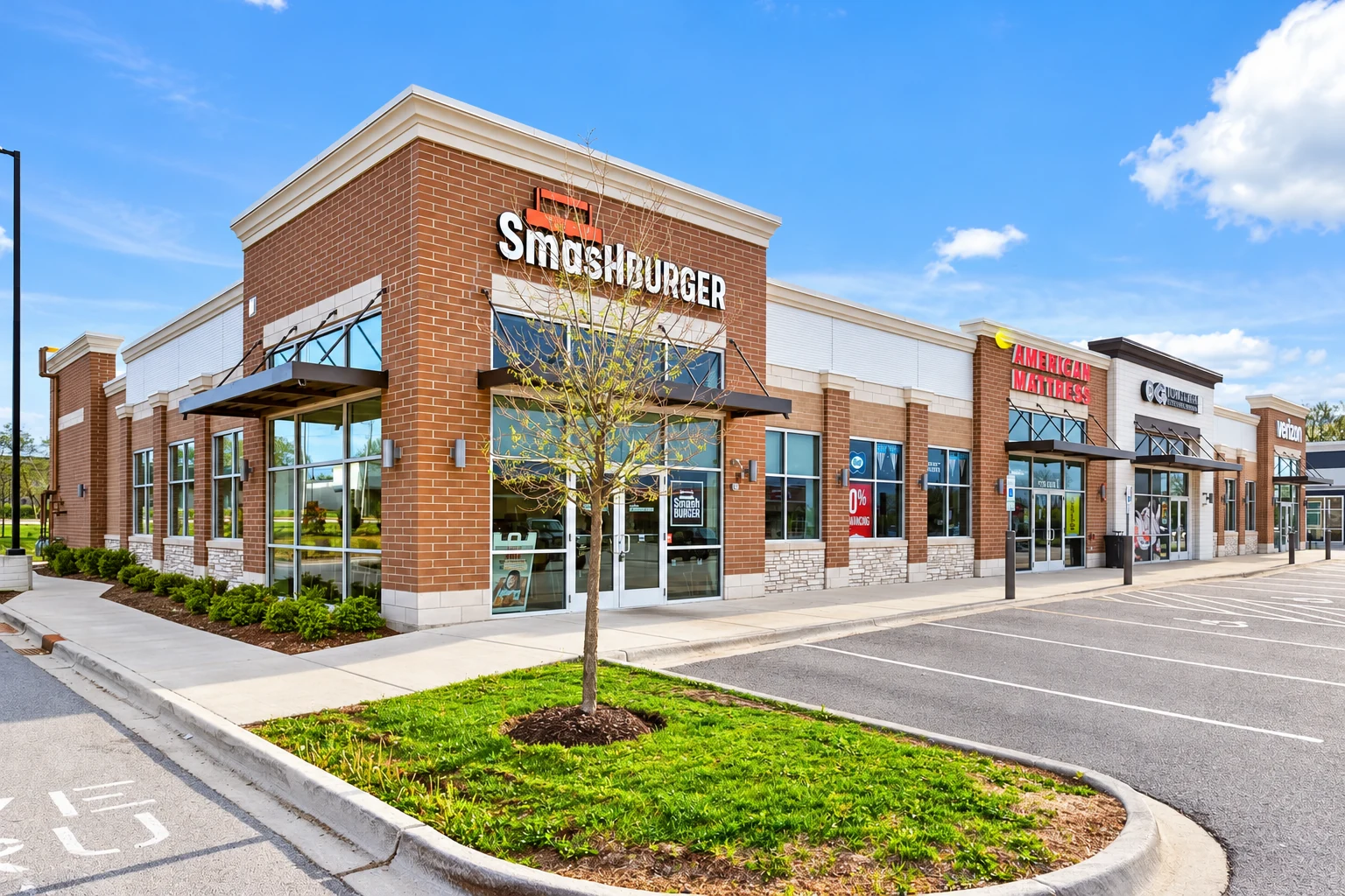 Retail and restaurant building exteriors and walkway at the Oak Brook development.