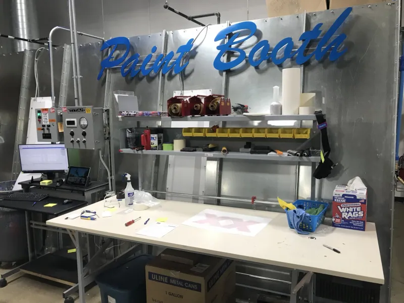 ER2 paint booth work area with electrical control equipment and surface-mounted conduit