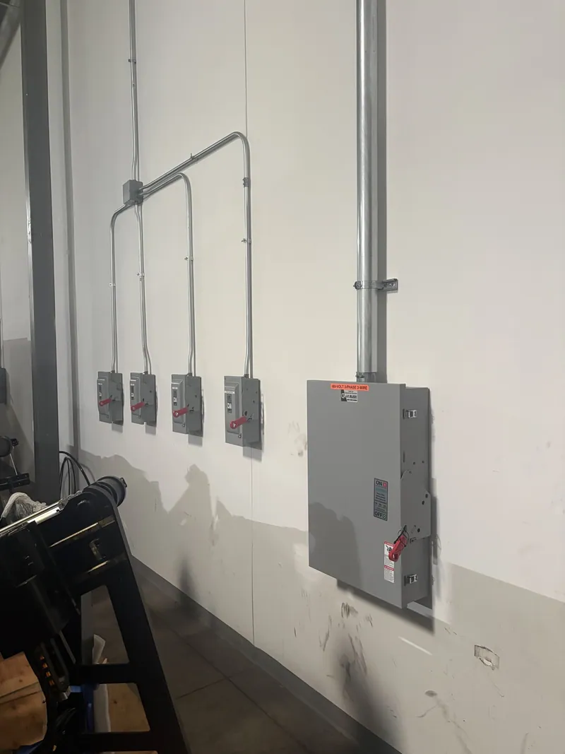 Industrial equipment disconnect switches and electrical conduit at HK Laser in Bartlett