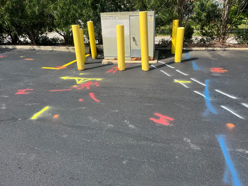 Utility markings around the transformer show the congested underground work area.