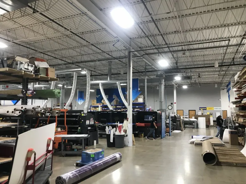 ER2 production floor with large-format printers and overhead lighting