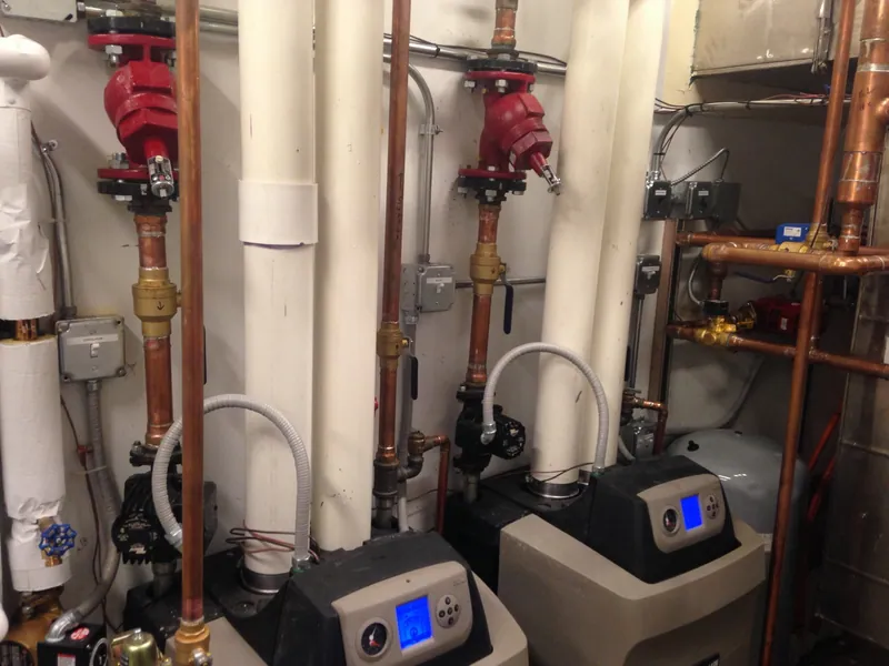 Heating equipment, circulating pumps, electrical switches, and flexible conduit in a mechanical room