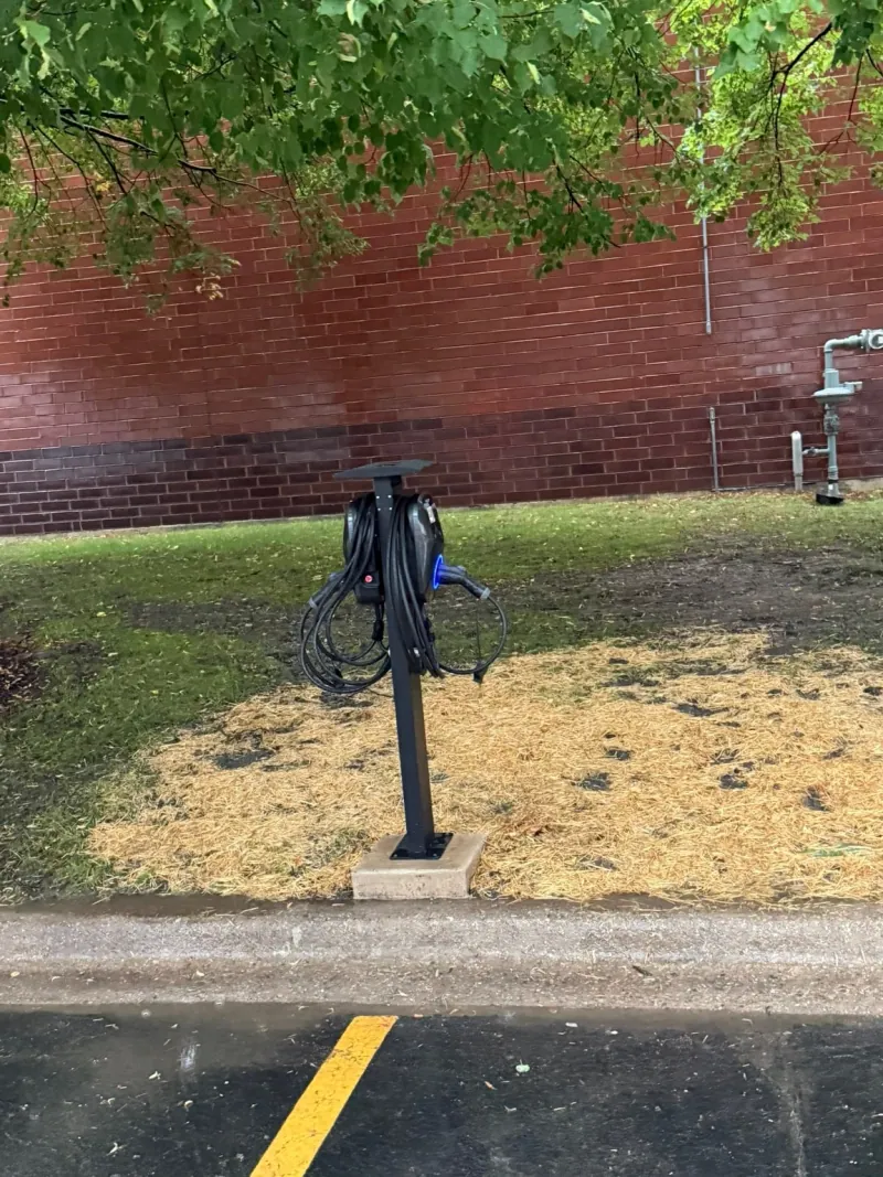 Pedestal-mounted electric vehicle charging equipment beside the ER2 parking area