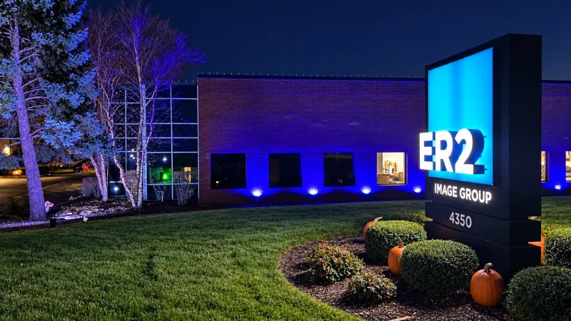ER2 Image Group exterior at night with blue facade lighting and illuminated monument sign