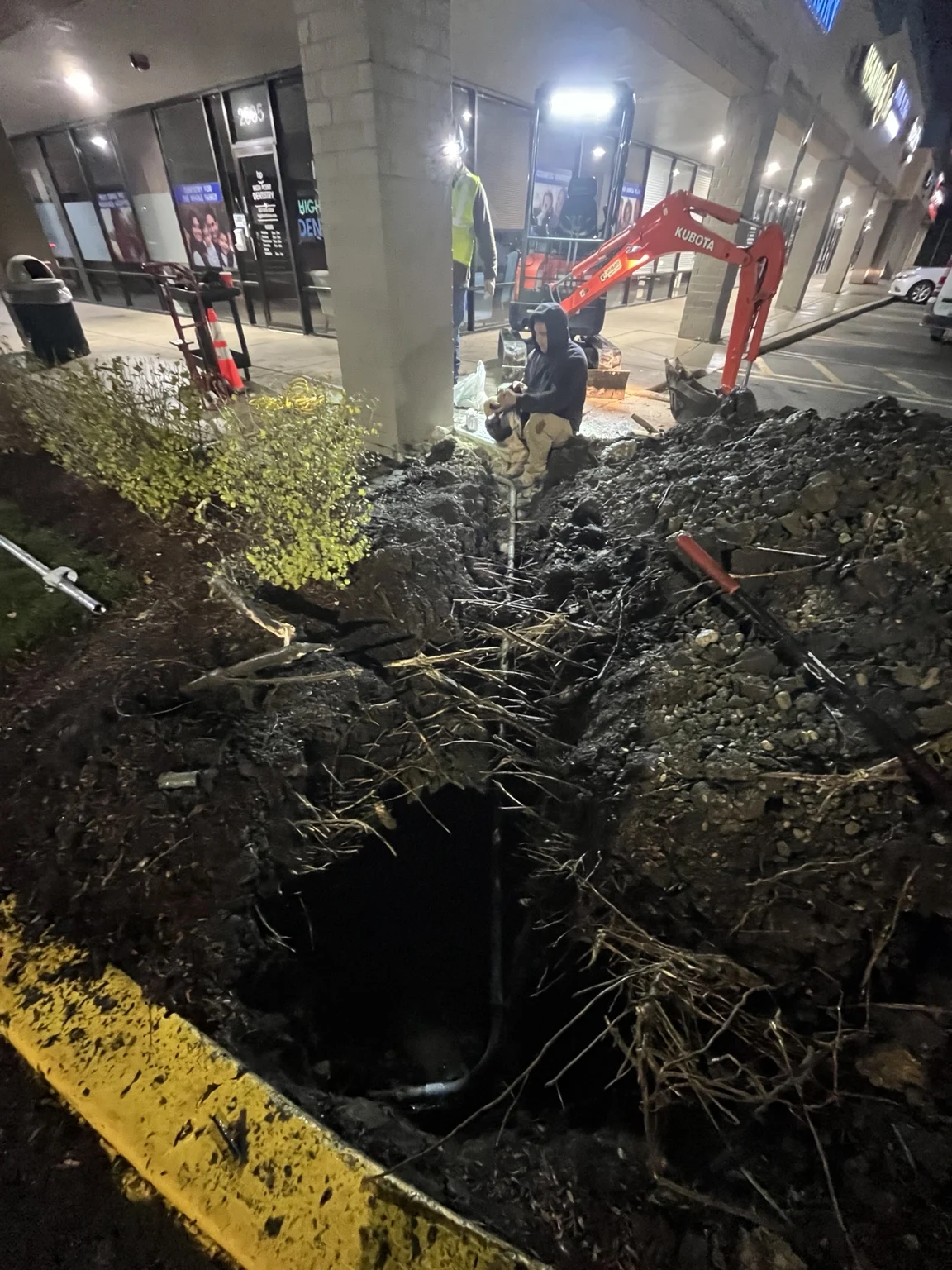 The crew working along the exposed underground conduit during the overnight repair.