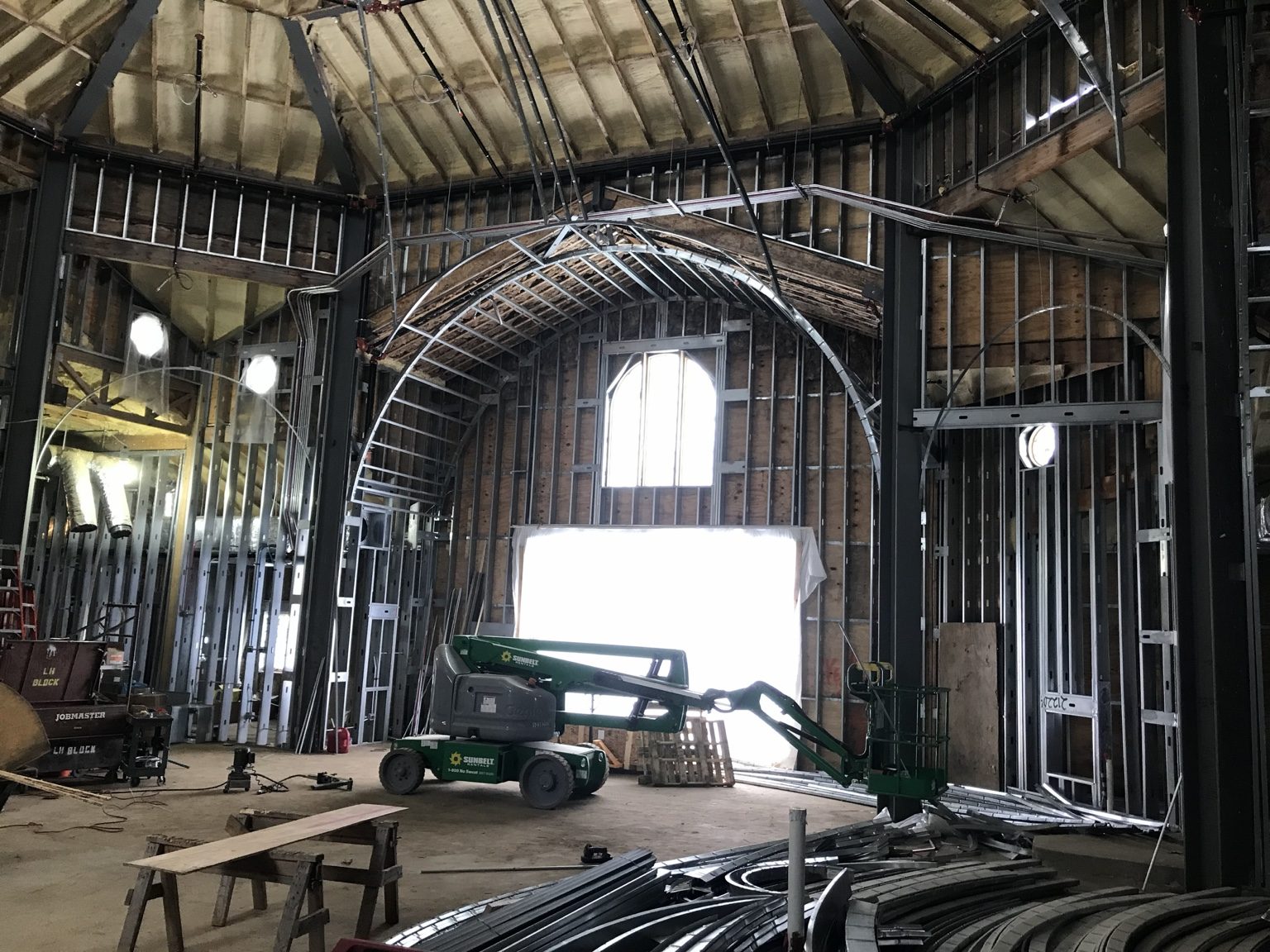 Church interior under construction with metal framing and a lift at St. Sophia in Elgin.