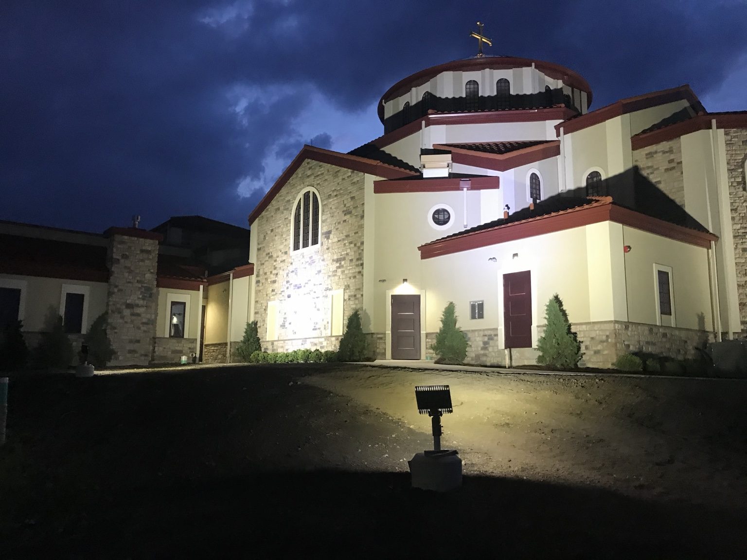 St. Sophia Greek Orthodox Church exterior illuminated at dusk in Elgin, Illinois.