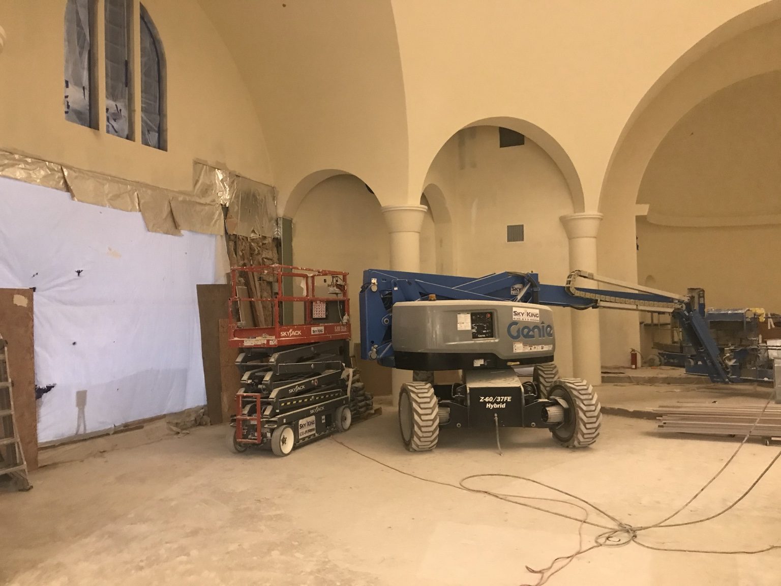 Interior construction with arched openings and lift equipment at St. Sophia church.