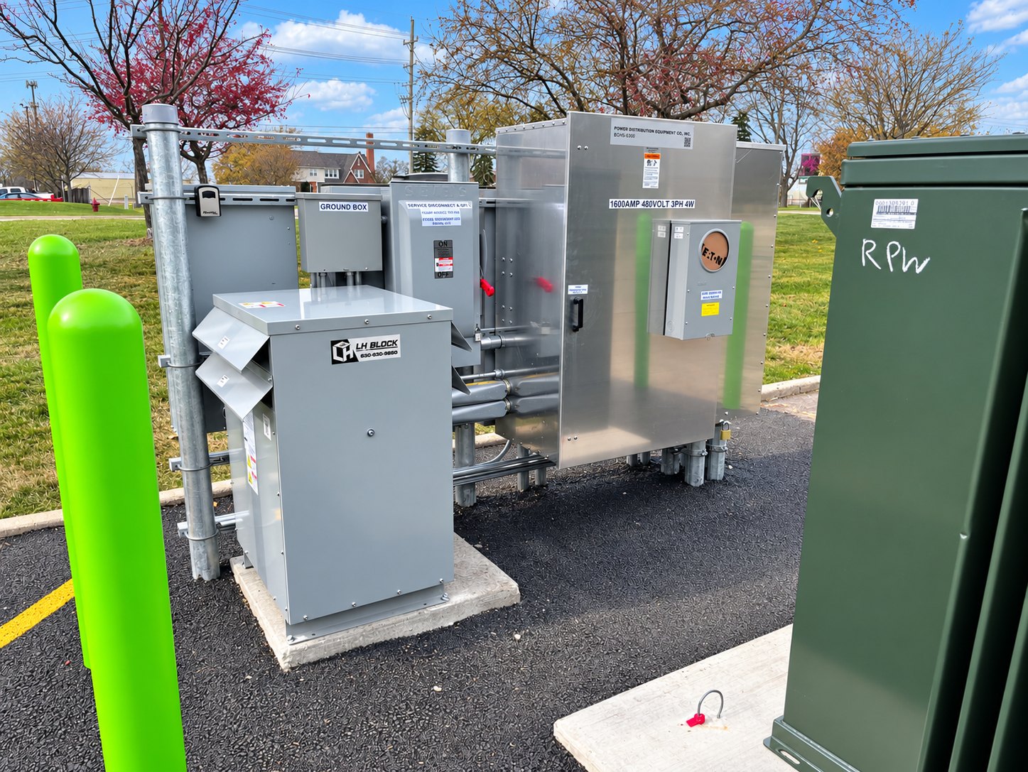 Electrical equipment, conduit, and LH Block identification labels at the Villa Park charging site.